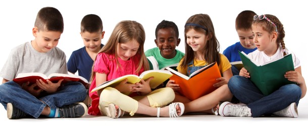 Group of happy multiracial school children reading books